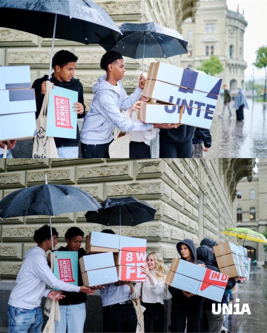 Eine Gruppe von Menschen steht im Regen neben einem Steingebäude und hält Regenschirme sowie Kisten mit den Aufschriften „UNTE“, „IND“ und „EMPFENFEL“ in den Händen. In der rechten unteren Ecke ist das Unia-Logo zu sehen.
